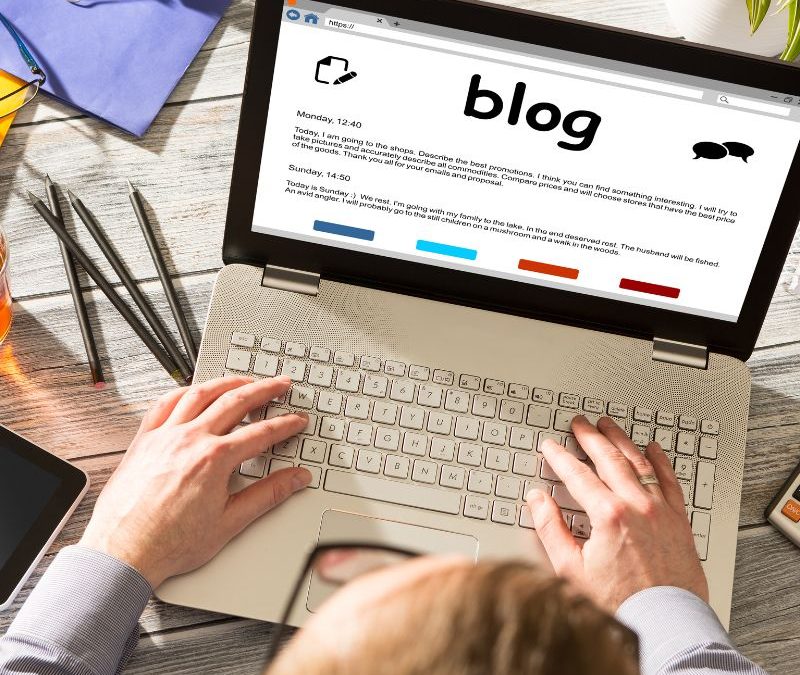 Image of a lap top using with the wrod blog on it